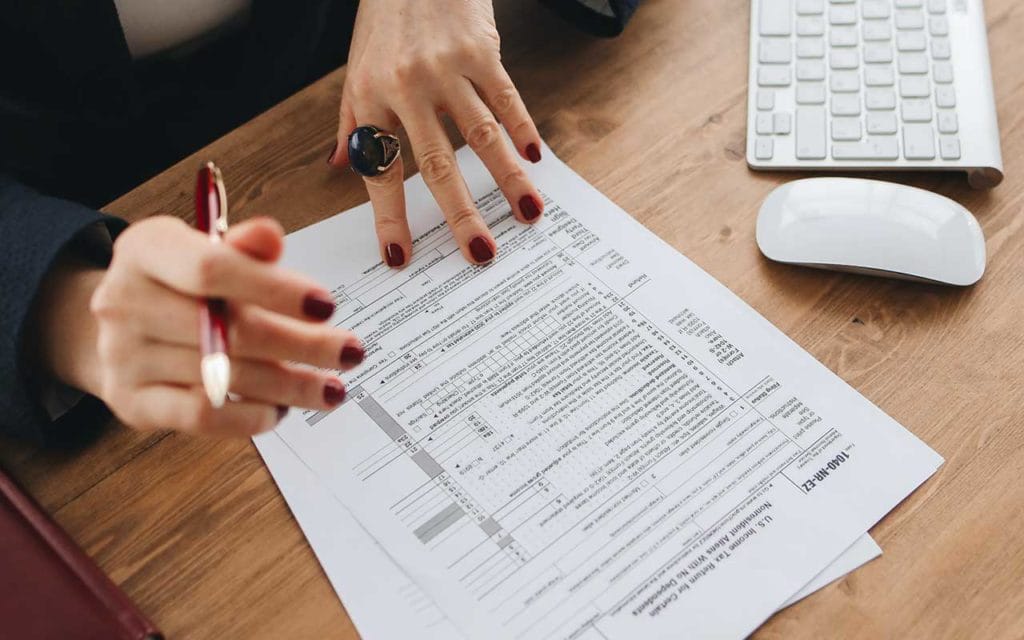 Homebuyers reviewing paperwork and costs for buying a house Title:
